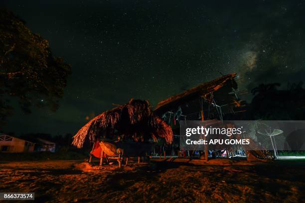 Night view at the Manilha village on the Waiapi indigenous reserve in Amapa state in Brazil on October 12, 2017. The Waiapi are one of the most...