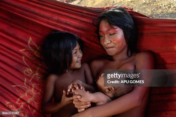 Meri Waiapi cares children at the Waiapi indigenous reserve in Amapa state in Brazil on October 14, 2017. The tiny Waiapi tribe is resisting moves by...