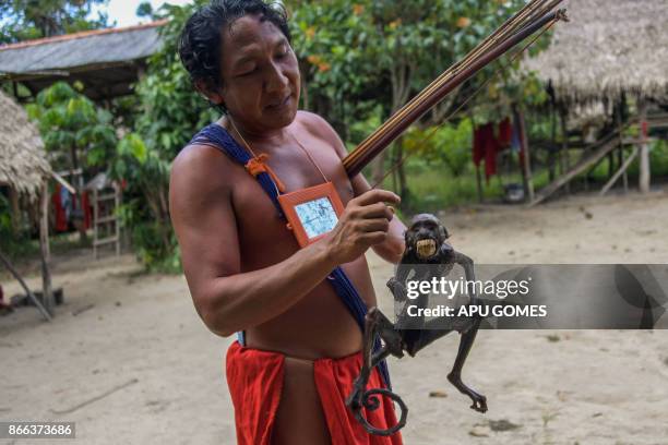 Chieftain Japarupi Waiapi shows a roasted monkey -part of Waiapi's diet, also based in Manioc and fruits- at the reserve in Amapa state in Brazil on...