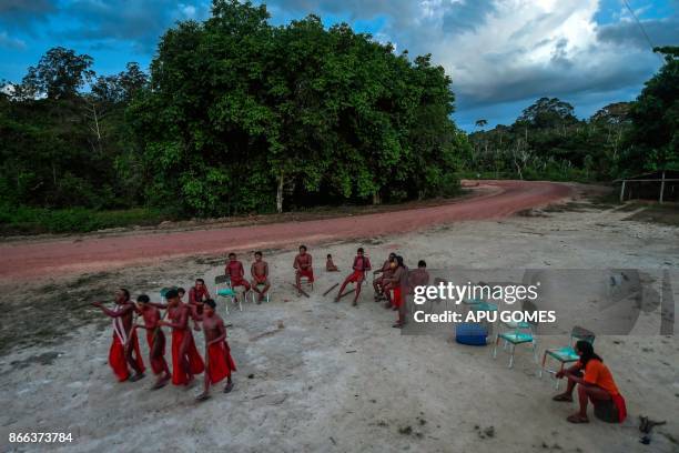 Waiapi men dance and play flute during the Anaconda's party -during which they make flutes to play and dance, and at the end leave all flutes on the...