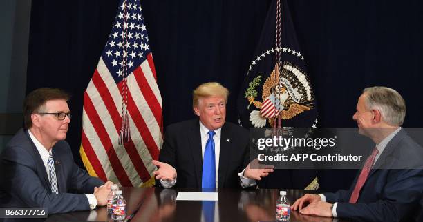 President Donald Trump speaks with Texas Governor Greg Abbott and Lieutenant Governor Dan Patrick during a briefing on hurricane relief efforts in...