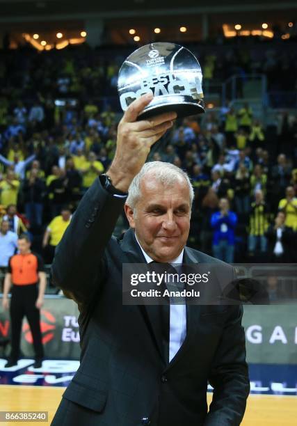 Head coach Zeljko Obradovic of Fenerbahce Dogus raises the best coach trophy ahead of the Turkish Airlines Euroleague basketball match between...