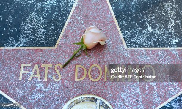 Rose lays on the Hollywood Walk of Fame Star of Fats Domino on October 25 in Hollywood, California. Fats Domino, whose rollicking boogie-woogie piano...