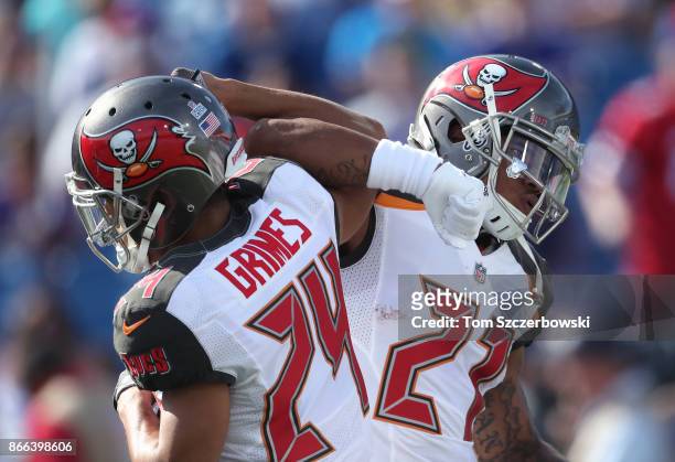Justin Evans of the Tampa Bay Buccaneers locks arms with Brent Grimes as they warm up prior to the start of NFL game action against the Buffalo Bills...