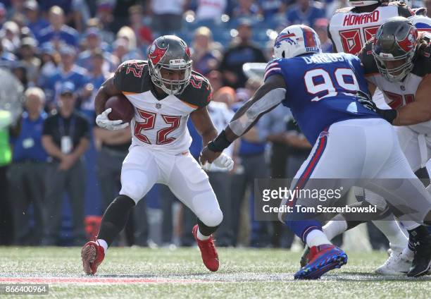 Doug Martin of the Tampa Bay Buccaneers runs with the ball during NFL game action as Marcell Dareus of the Buffalo Bills defends at New Era Field on...