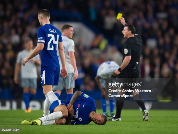 Everton's James McCarthy is shown a yellow card by Referee Neil Swarbrick after fouling Chelsea's Kenedy during the Carabao Cup Fourth Round match...