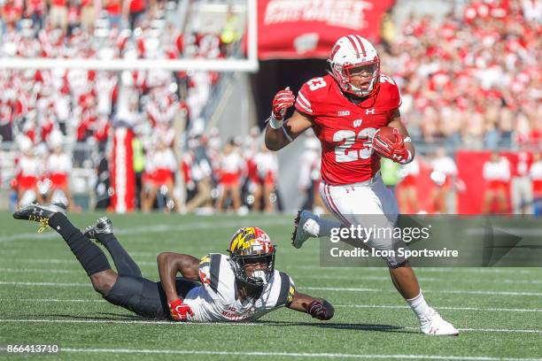 Wisconsin Badger running back Jonathan Taylor eludes a tackle by Maryland Terrapin defensive back Darnell Savage Jr. During a Big Ten football game...