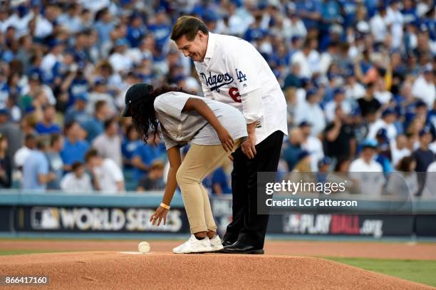 Boys & Girls Club of America member Alanna Moore delivers the first ball iwht Steve Garvey prior to Game 2 of the 2017 World Series between the...