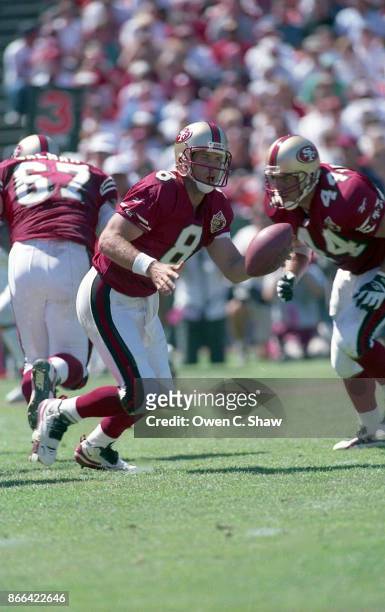 Steve Young of the San Francisco 49ers drops back to pass against the New Orleans Saints at Candlestick Park circa 1996 in San Francisco,California.