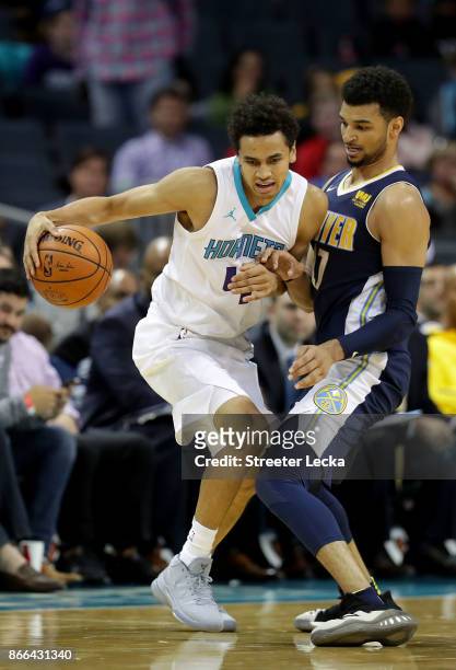 Jamal Murray of the Denver Nuggets tries to stop Marcus Paige of the Charlotte Hornets during their game at Spectrum Center on October 25, 2017 in...