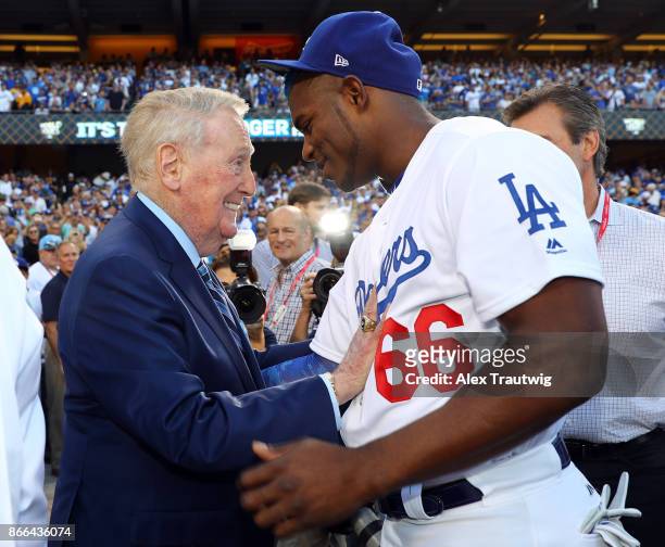 Hall of Fame broadcaster Vin Scully talks to Yasiel Puig of the Los Angeles Dodgers before Game 2 of the 2017 World Series against the Houston Astros...