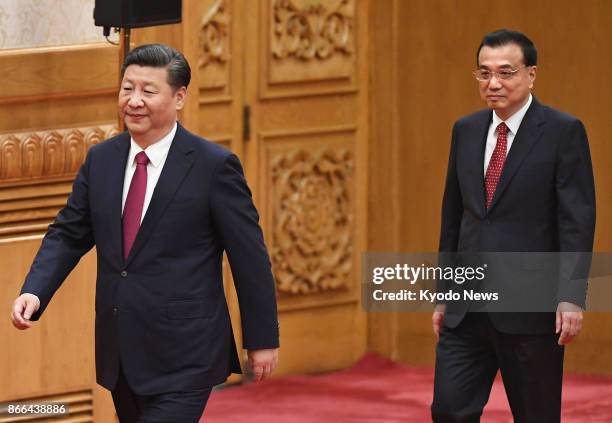 Chinese President Xi Jinping and Premier Li Keqiang attend a press conference at the Great Hall of the People in Beijing on Oct. 25 a day after the...