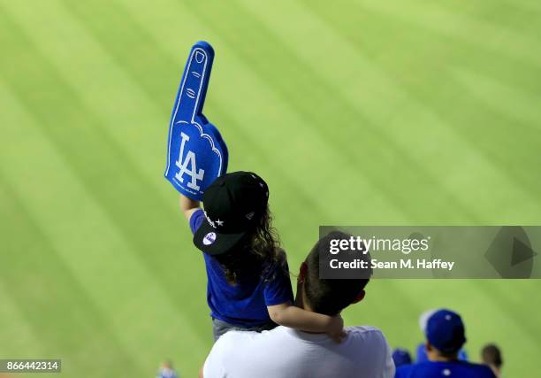 Young Los Angeles Dodgers fan holds up a foam finger during game two of the 2017 World Series between the Houston Astros and the Los Angeles Dodgers...