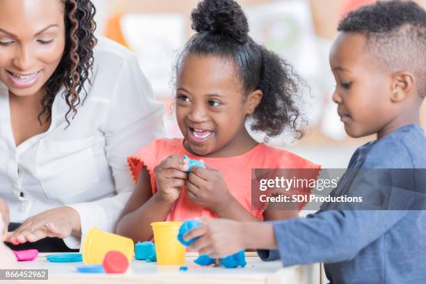 preschool students play with modeling clay - child's play clay stock pictures, royalty-free photos & images