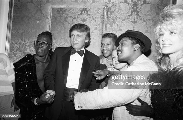 Shabba Ranks, Donald Trump, Unidentifed, Cyndi Lauper, Unidentified and Marla Maples pose for a photo at a Grammy Awards party at the Plaza Hotel in...