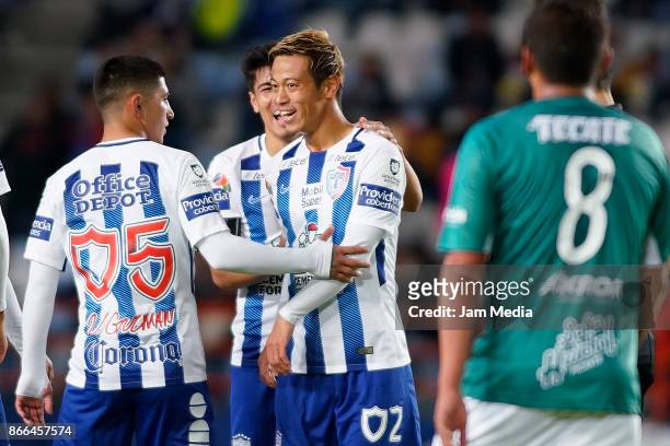 Keisuke Honda of Pachuca celebrates with teammate Victor Guzman after scoring the third goal of his team during the round of sixteen match between...