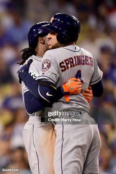 George Springer of the Houston Astros celebrates after hitting a two-run home run during the eleventh inning against the Los Angeles Dodgers in game...