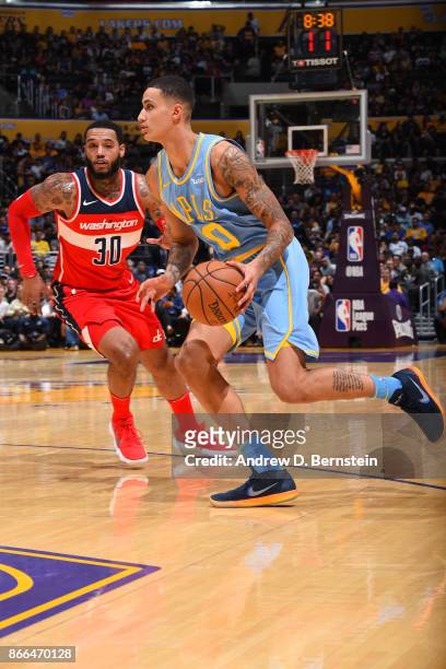 Kyle Kuzma of the Los Angeles Lakers handles the ball against the Washington Wizards on October 25, 2017 at STAPLES Center in Los Angeles,...