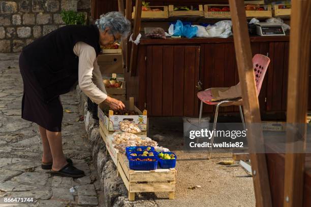 woman attends to her stall - ston croatia stock pictures, royalty-free photos & images