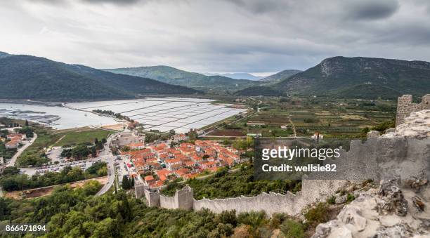 looking down the walls of ston towards the salt pans - ston croatia stock pictures, royalty-free photos & images
