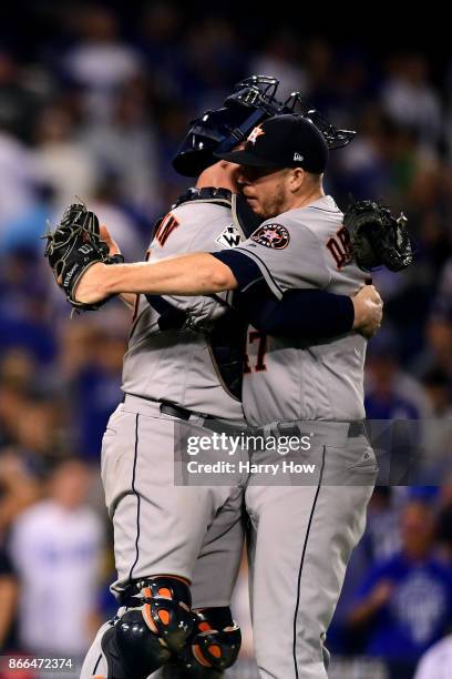 Brian McCann celebrates with Chris Devenski of the Houston Astros after defeating the Los Angeles Dodgers 7-6 in eleven innings to win game two of...