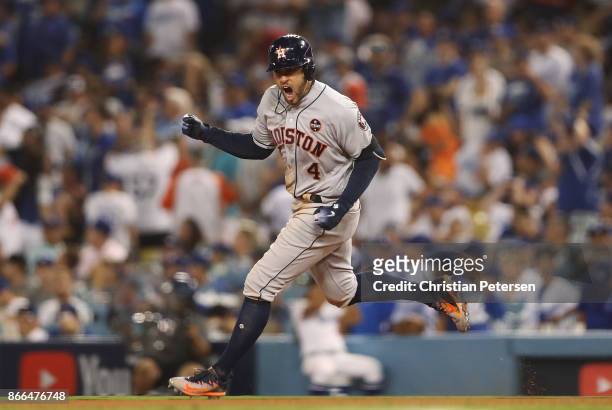 George Springer of the Houston Astros runs the bases after hitting a two-run home run during the eleventh inning against the Los Angeles Dodgers in...