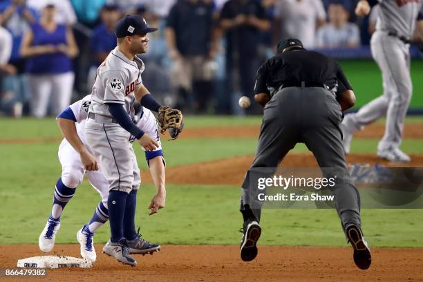 Umpire Laz Diaz is hit by a ball thrown by Chris Devenski of the Houston Astros during the tenth inning in game two of the 2017 World Series between...