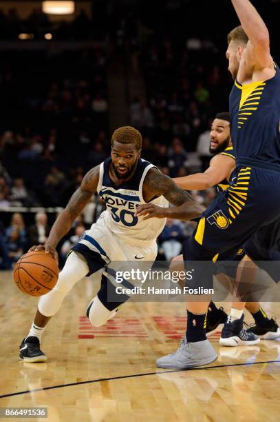 Aaron Brooks of the Minnesota Timberwolves drives to the basket against Cory Joseph and Domantas Sabonis of the Indiana Pacers during the game on...