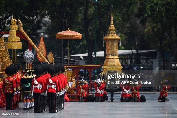 Royal guards gesture before the Royal Urn during the funeral procession of the late Thai king Bhumibol Adulyadej in Bangkok on October 26, 2017. A...