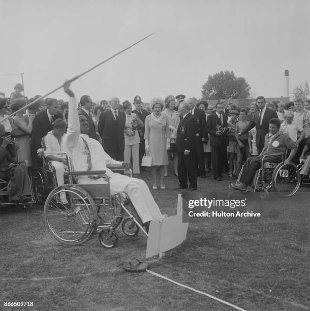 Queen Elizabeth II and German neurologist, founder of the 'Stoke Mandeville Games', Ludwig Guttmann watching the javelin events during the Games at...