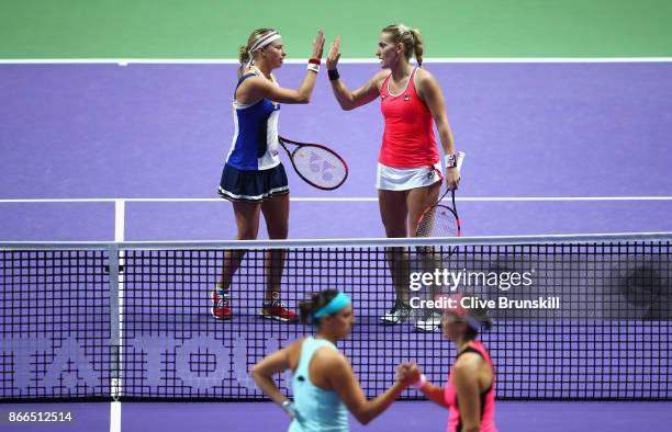 Andrea Hlavackova of Czech Republic and Timea Babos of Hungary celebrate victory in their doubles match against Maria Jose Martinez Sanchez of Spain...