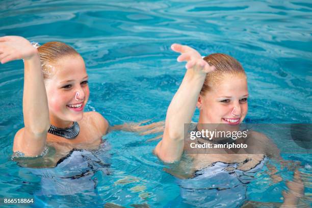 women in sport - smiling synchronized swimming sisters - synchronised swimming stock pictures, royalty-free photos & images