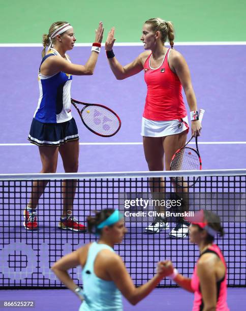 Andrea Hlavackova of Czech Republic and Timea Babos of Hungary celebrate victory in their doubles match against Maria Jose Martinez Sanchez of Spain...