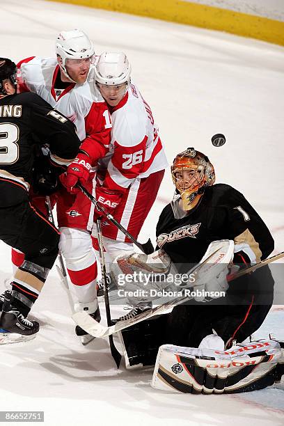 Erik Christensen and Pavel Datsyuk of the Detroit Red Wings fight for the puck outside the crease against Jonas Hiller and Brett Festerling of the...