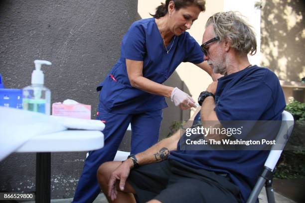 Paulina Bobenrieth a nurse with the HHSA Public Health dept. Gives a Hepatitis A vaccine to a Homeless person in Downtown San Diego, CA on Wednesday,...