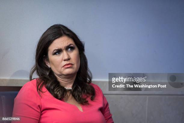 White House press secretary Sarah Huckabee Sanders looks to White House Chief of Staff John Kelly as he takes questions and talks about his son...