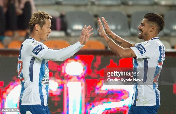 Keisuke Honda celebrates with Franco Jara after scoring in the first half of Pachuca's 5-0 win at home to Atletico Zacatepec in the first round of...