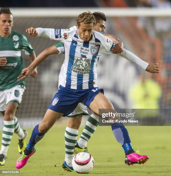 Pachuca's Keisuke Honda shields the ball in the first half of a Copa MX first-round match at home against Atletico Zacatepec on Oct. 25, 2017. Honda...