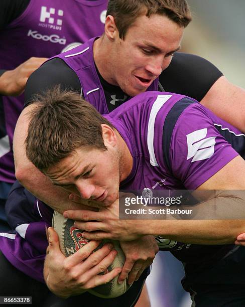 Brett Anderson is tackled by James Maloney during a Melbourne Storm NRL training session held at Visy Park on May 8, 2009 in Melbourne, Australia.