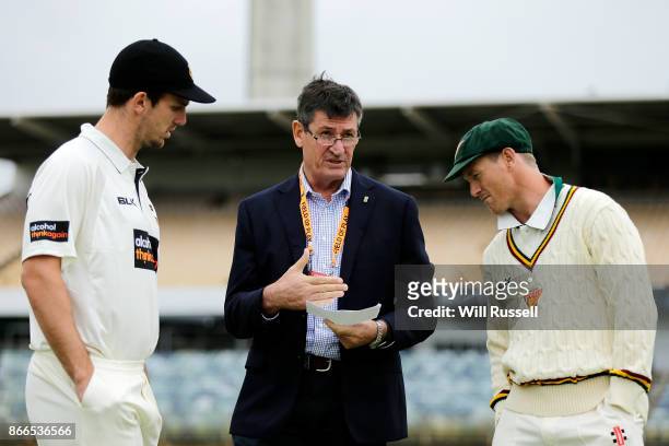 Match referee Steve Bernard talks to team captains Mitchell Marsh of the Warriors and George Bailey of the Tigers about the rain delay during day one...