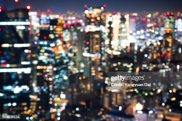 defocused view of skyscrapers at night - yongyuan tokyo stock pictures, royalty-free photos & images