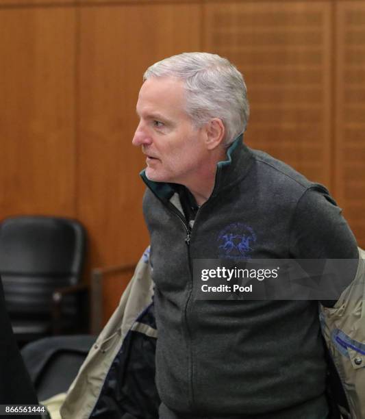 Daniel M. Takes off his coat as he arrives for his trial on charges of spying for the Swiss government October 26, 2017 in Frankfurt Main, Germany.....