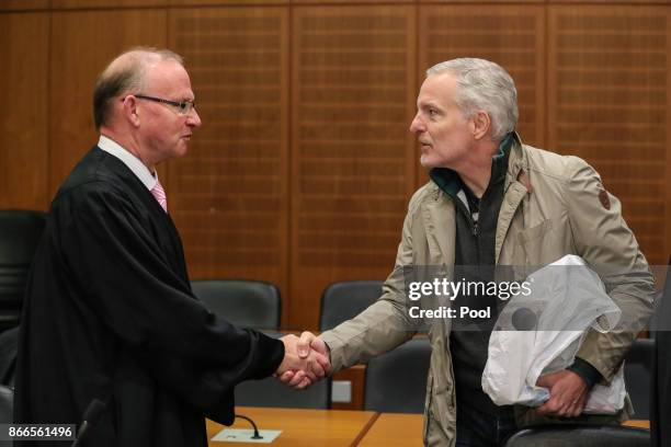 Daniel M. Shakes hand with Hannes Linke , his lawyer, as arrives for his trial on charges of spying for the Swiss government October 26, 2017 in...