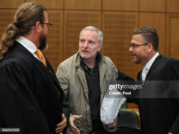 Daniel M. Shakes hand with his lawyers Robert Kain and Thomas Koblenzer as he arrives for his trial on charges of spying for the Swiss government, on...