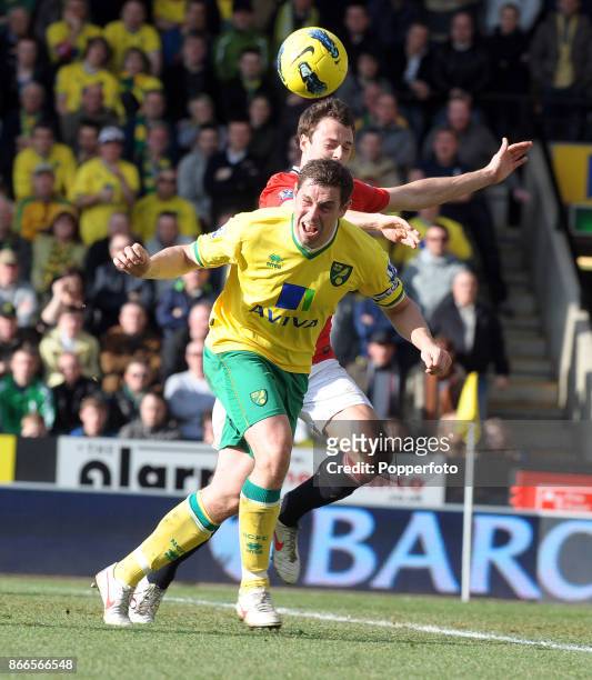 Grant Holt of Norwich City and Jonny Evans of Manchester United battle for the ball during the Barclays Premier League match at Carrow Road on...