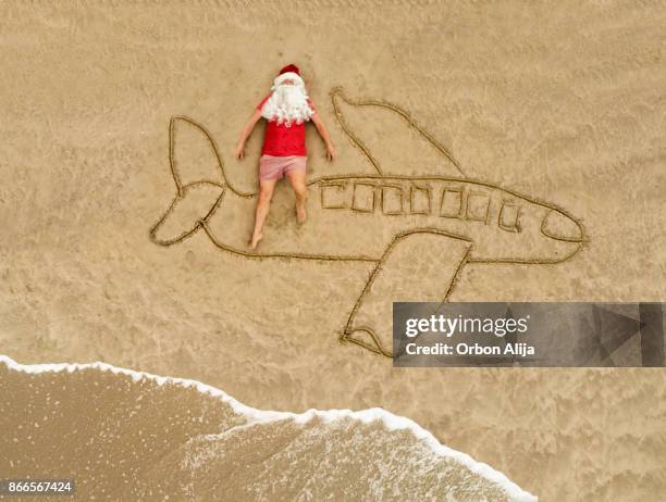 santa claus at the beach - santa claus lying stock pictures, royalty-free photos & images