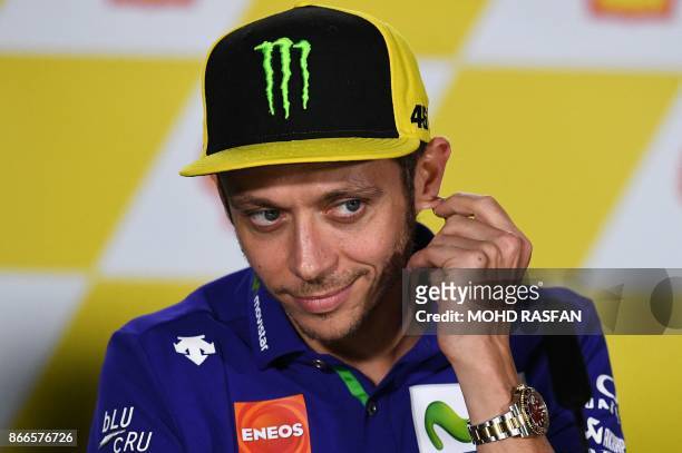 Movistar Yamaha Italian rider Valentino Rossi gestures during a press conference ahead of the Malaysia MotoGP at the Sepang International circuit in...