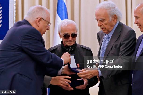 Israeli President Reuven Rivlin presents French-Armenian singer Charles Aznavour the Raoul Wallenberg medal on October 26, 2017 at the presidential...