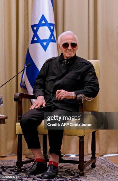 French-Armenian singer Charles Aznavour attends a ceremony on October 26, 2017 at the presidential compound in Jerusalem. Aznavour was presented with...