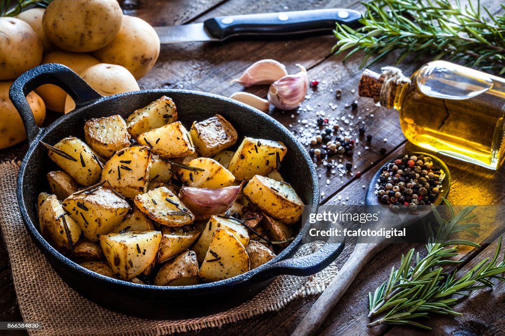 Roasted potatoes on wooden kitchen table